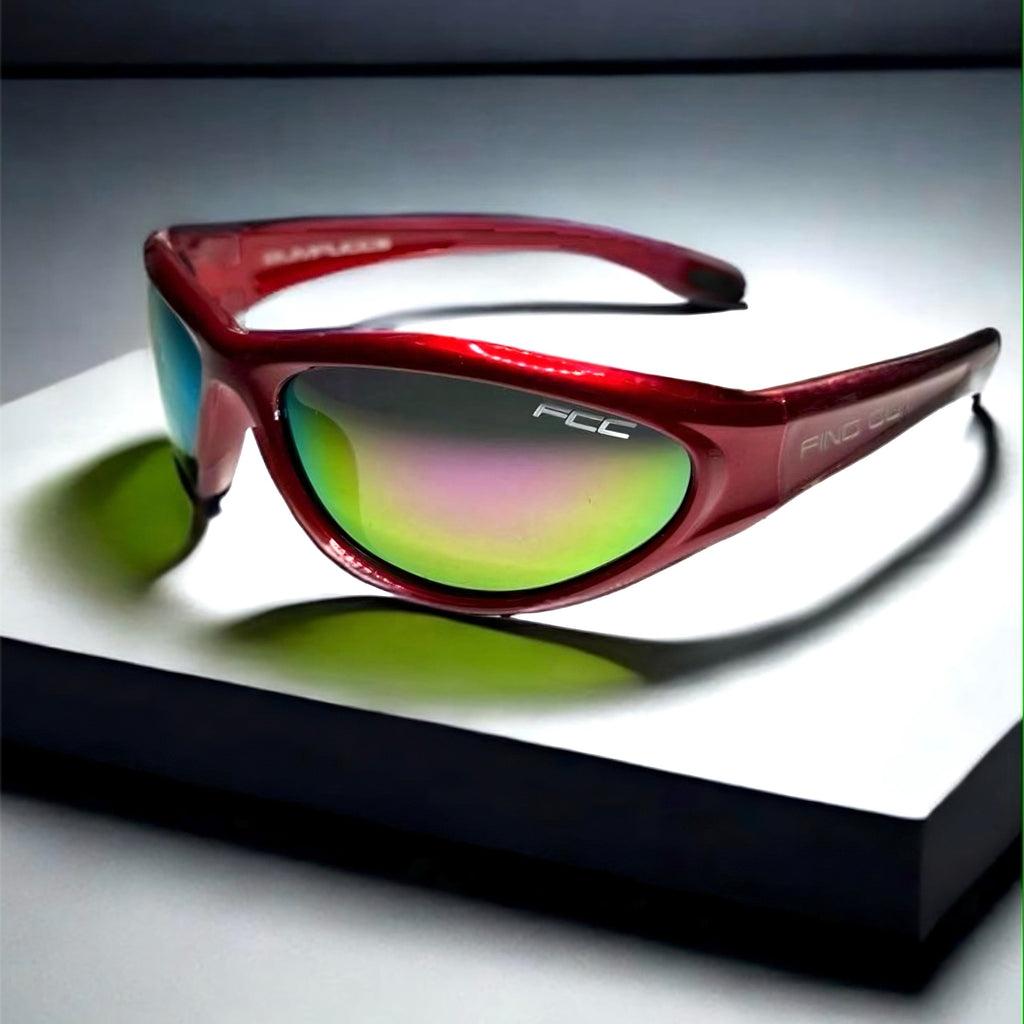 A pair of red full wrap peripheral protection sports sunglasses with green polarized lenses, placed on a white surface.